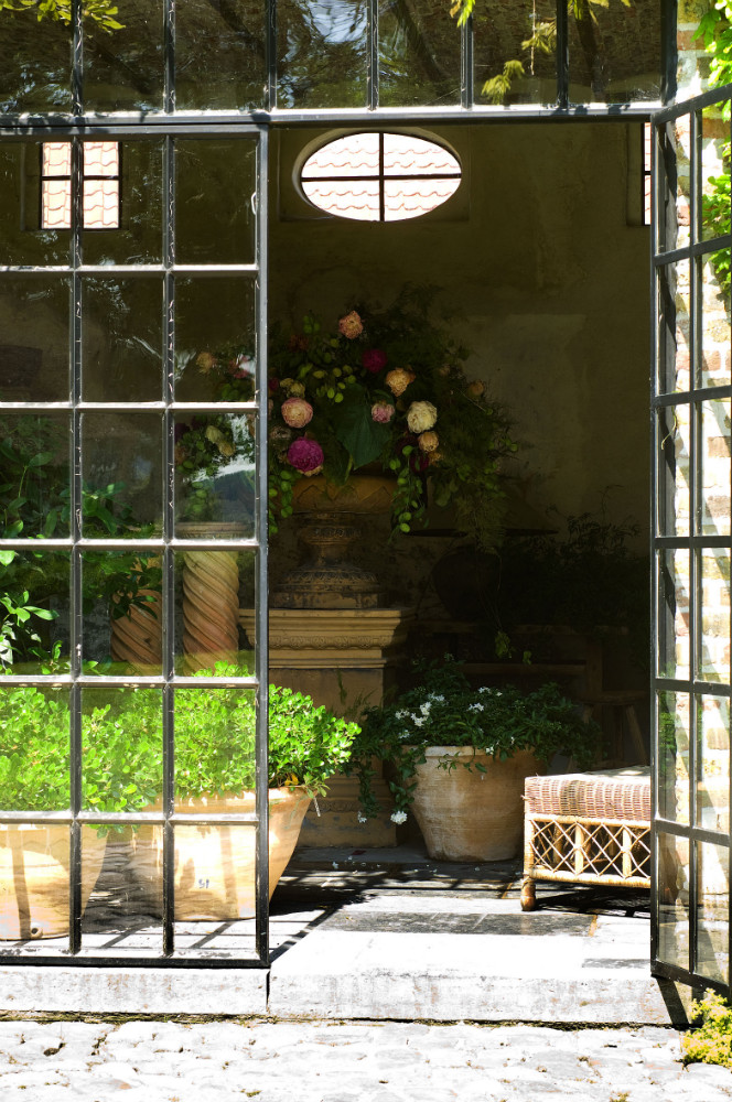 A breathtaking peek beyond steel and glass doors at potted bliss at The Little Monastery. Come enjoy photos of Old World Style and Rustic European Antiques in a Serene Countryside Setting in Belgium.